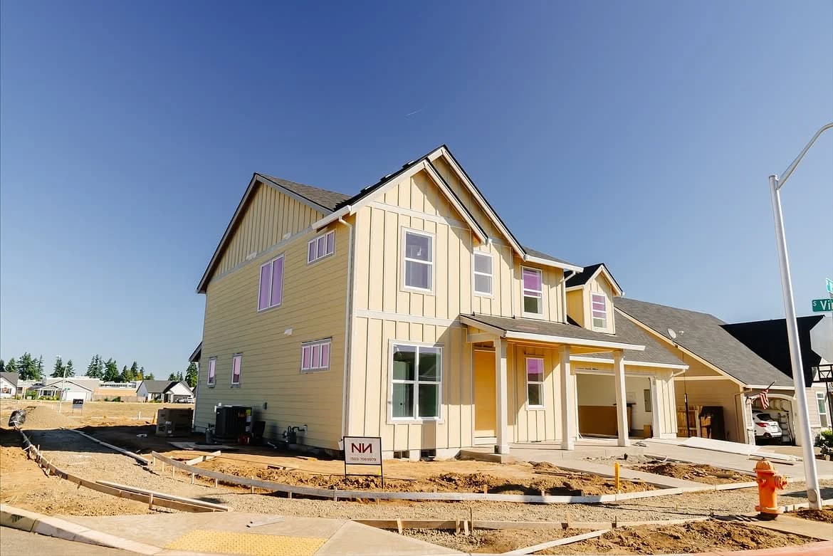 Two-story home under construction at an HVAC installation site