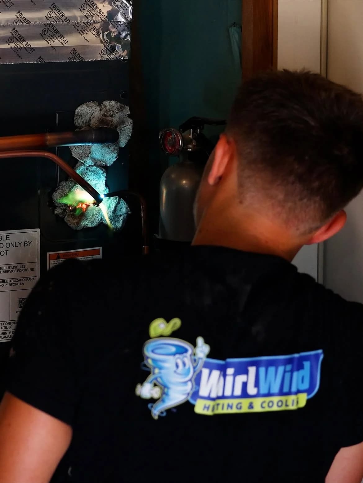 Whirlwind technician inspecting the controls inside a furnace