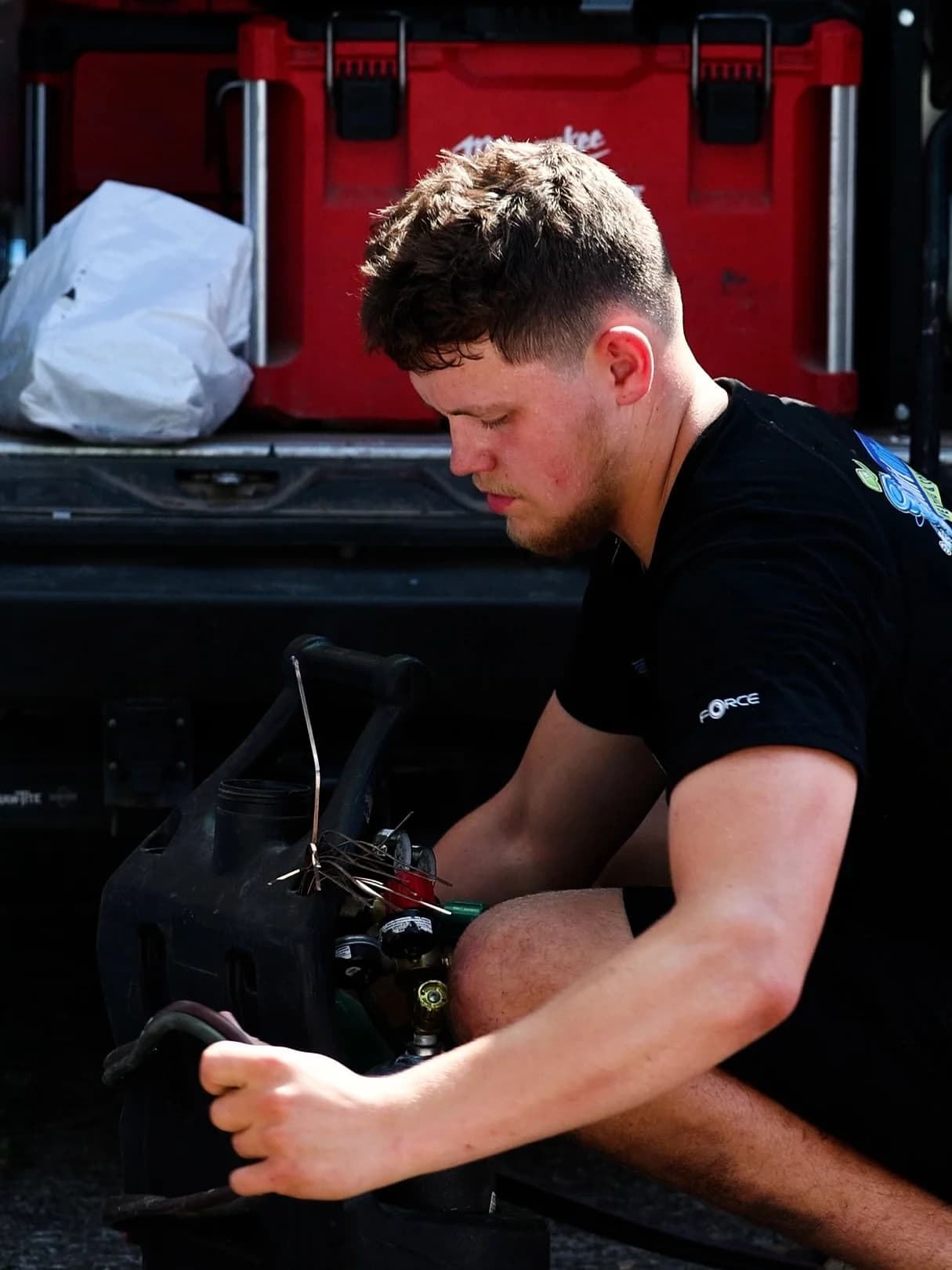 Whirlwind technician preparing equipment at the back of a service van