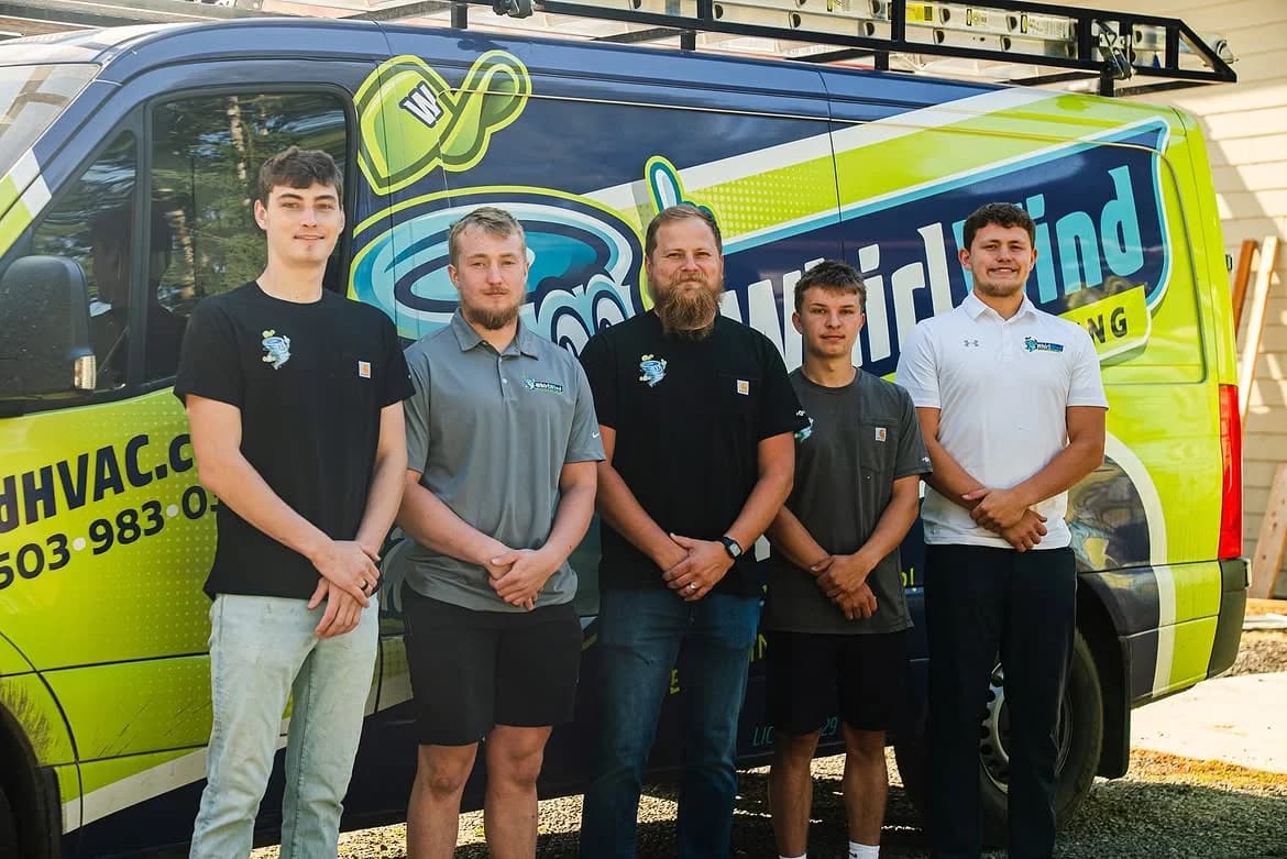 Five Whirlwind crew members standing in front of their branded service van